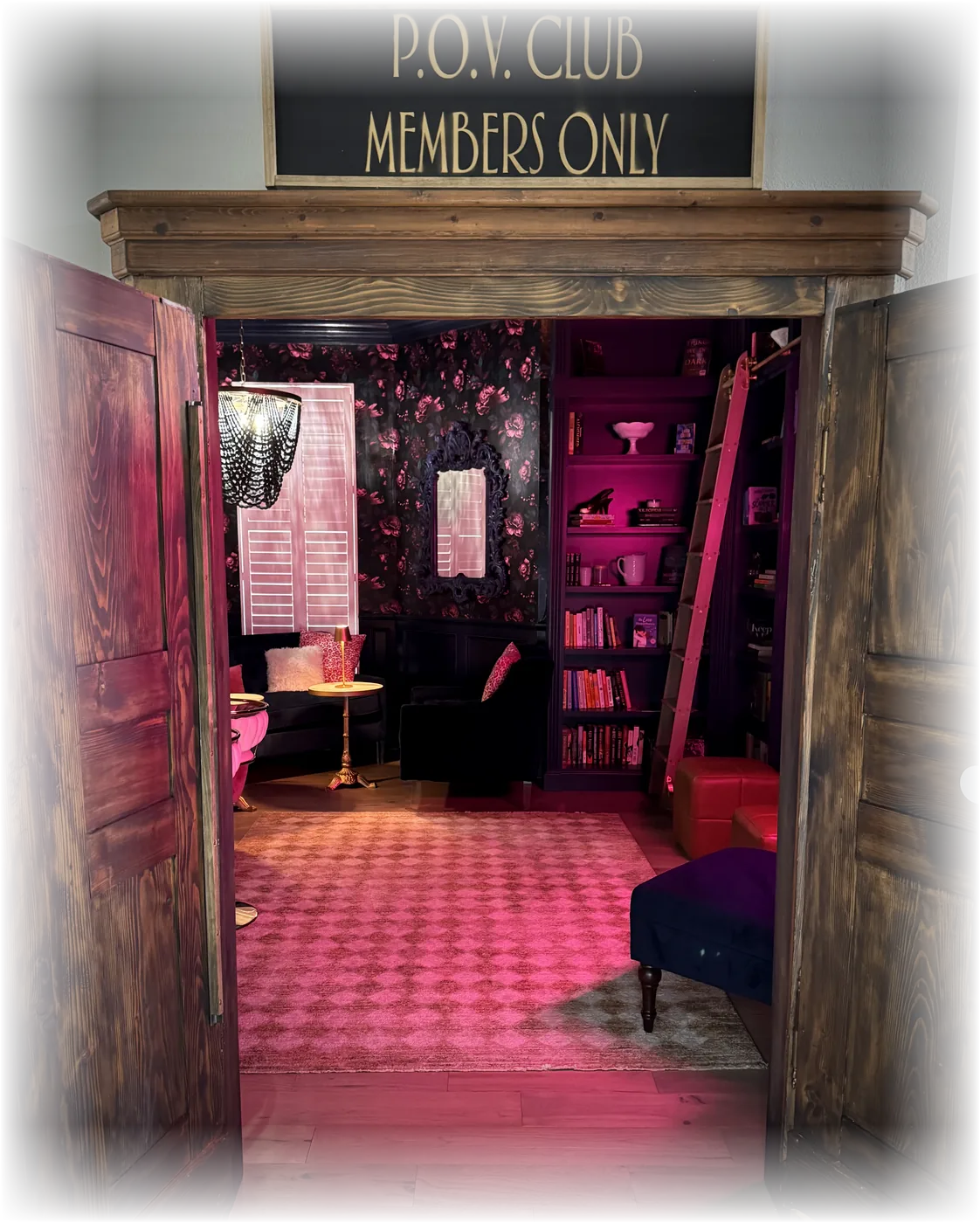 The armoire doors open onto the P.O.V. Club reading room, with a 'P.O.V. Club — Members Only' sign mounted above