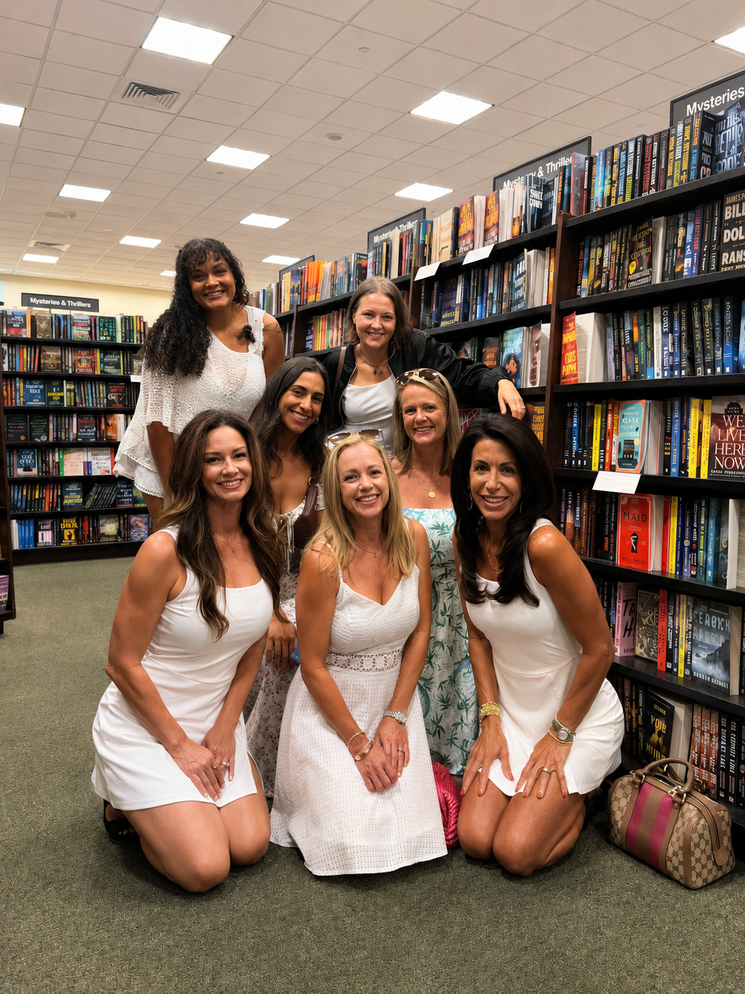 Book Fetish Mommas posing in front of the Mysteries & Thrillers shelves at the bookstore