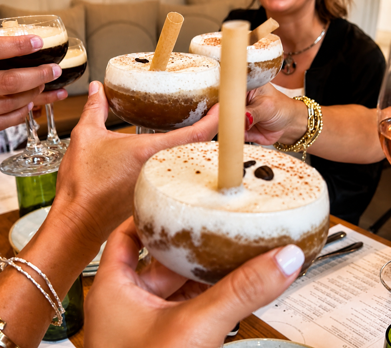 Book Fetish Mommas toasting with frozen espresso martinis topped with foam and coffee beans