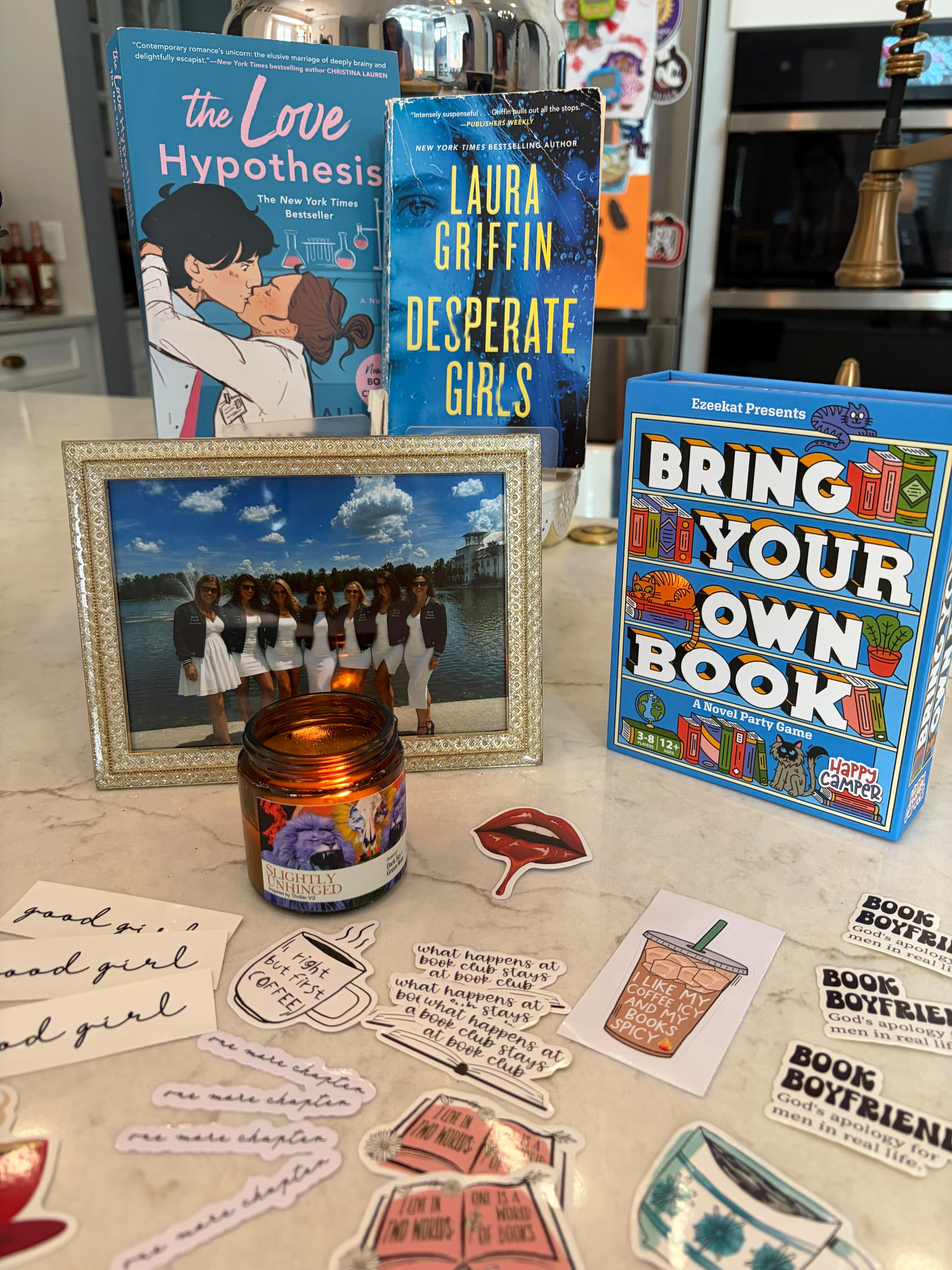 July’s picks The Love Hypothesis and Desperate Girls with the Book Fetish Momma group photo and the Bring Your Own Book party game